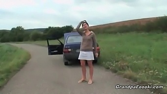 A Charming Young Woman Entices An Elderly Gentleman During A Roadside Encounter