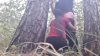 Lesbian Couple Shares Intimate Moments Under A Tree During A Rainy Day